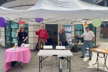 A photograph of Amy from Dacorum Community Trust standing outside The Roundhouse in Hemel Hempstead Town Centre.